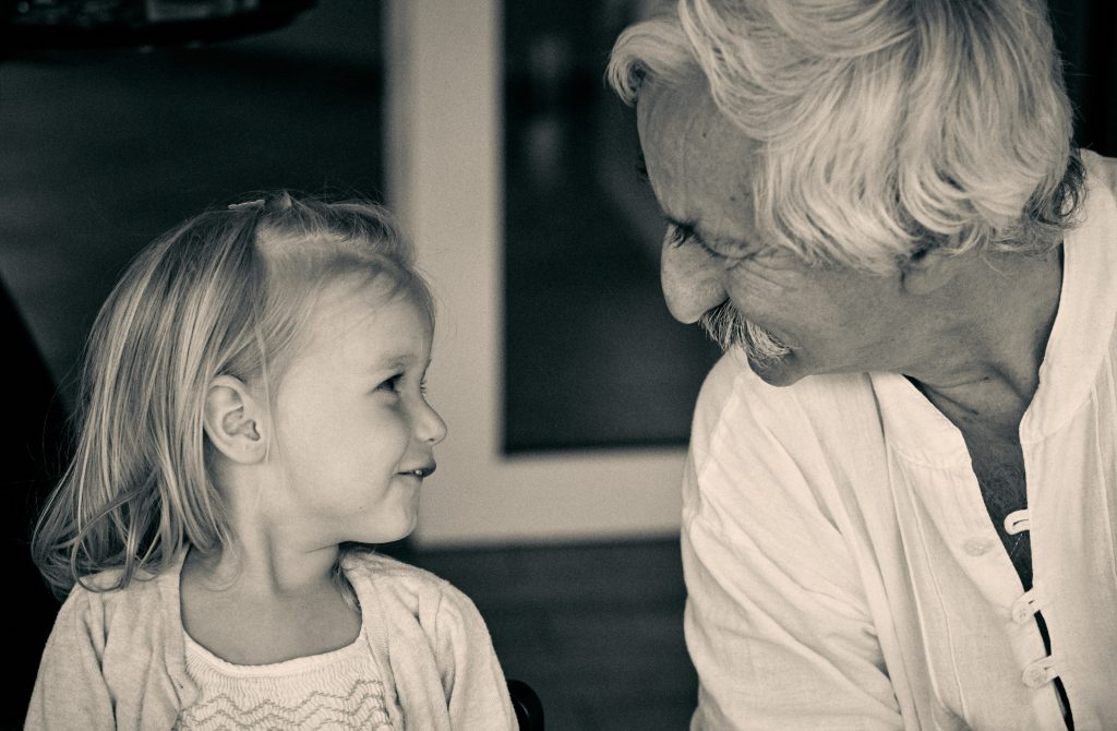 Black and white photo of young girl and older man with mustache sharing an intimate, joyful moment together - © Pascal Recchia. All rights reserved.