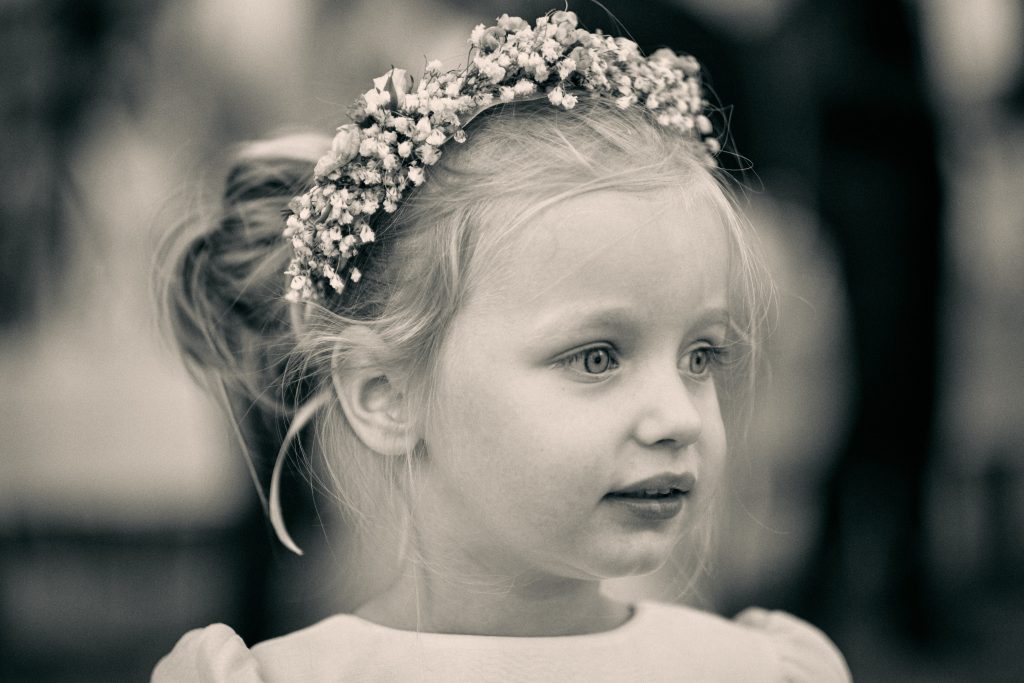 Young girl with blonde hair wearing ornate floral crown headpiece, black and white portrait photography with soft focus - © Pascal Recchia. All rights reserved.