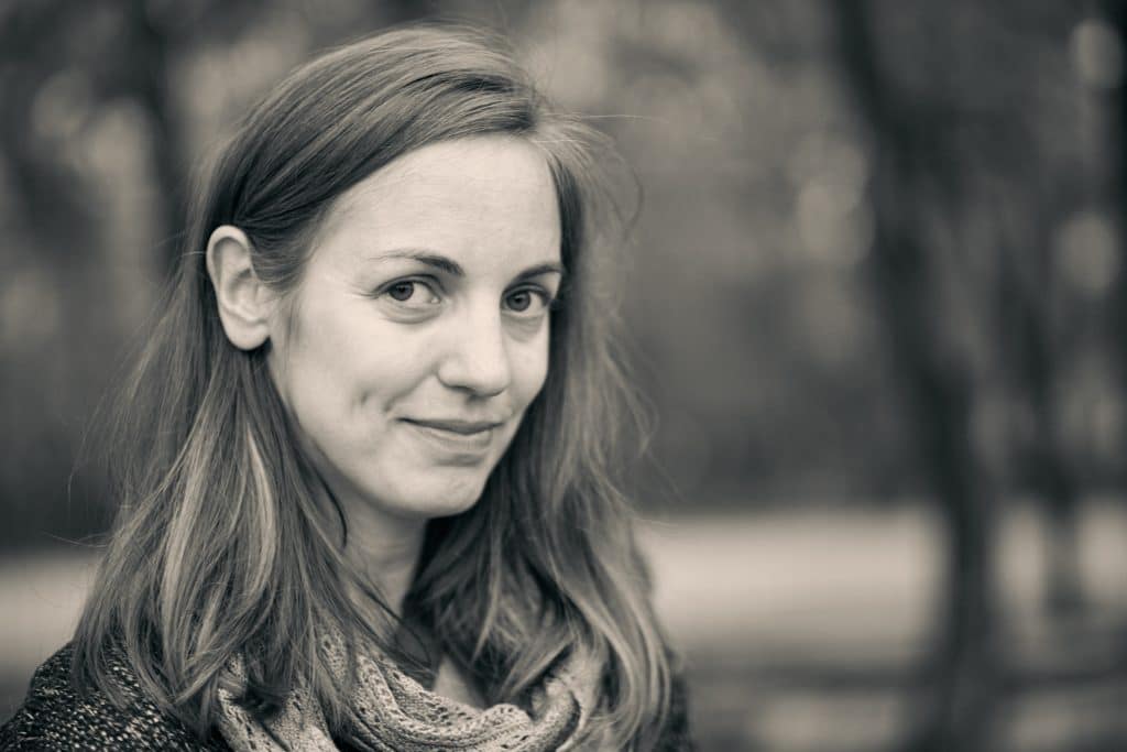 Portrait of woman with long brown hair and lace scarf, sepia-toned photo with soft focus background and gentle smile - © Pascal Recchia. All rights reserved.