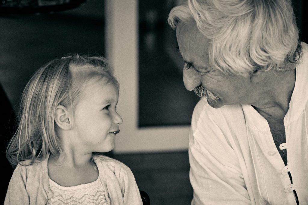 Black and white photo of young girl and older man with mustache sharing an intimate, joyful moment together - © Pascal Recchia. All rights reserved.